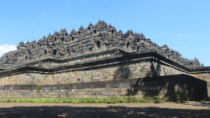 Fototapeta na wymiar The great architecture and art at Borobudur Temple, Indonesia. This temple is the largest Buddhist temple in the world and has been inaugurated by UNESCO