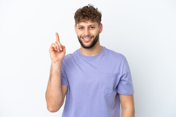 Fototapeta premium Young handsome caucasian man isolated on white background showing and lifting a finger in sign of the best