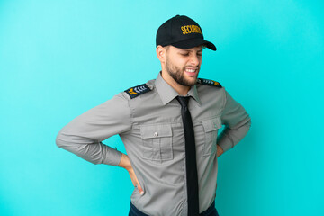 Young security man isolated on blue background suffering from backache for having made an effort