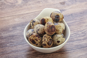 Raw quail eggs heap in the bowl