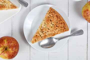 Top view of slice of traditional European apple pie with topping crumbles called 'Streusel'