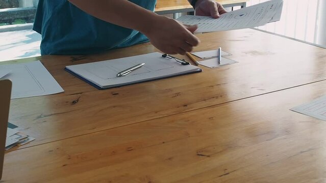 UX or UI designers preparing mockup layout prototype before application project meeting.