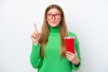 Young caucasian woman drinking soda isolated on white background pointing up a great idea