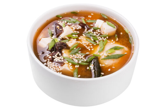 Thai soup with tofu and tree fungus, sprinkled with sesame seeds, on a white background, isolate