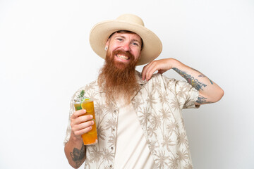 Redhead man with long beard drinking a cocktail on a beach isolated on white background laughing