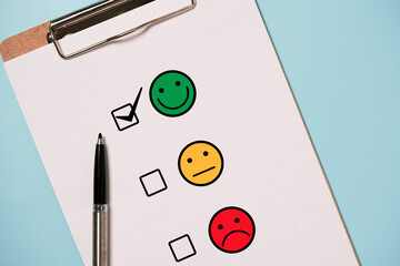 User use pen to check mark select smile face for customer evaluation survey after client use...