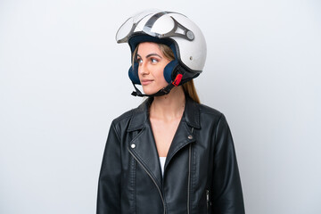 Young caucasian woman with a motorcycle helmet isolated on white background looking to the side