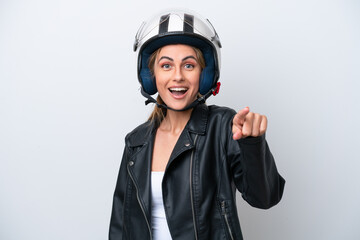 Young caucasian woman with a motorcycle helmet isolated on white background surprised and pointing front
