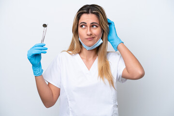 Dentist woman holding tools isolated on white background having doubts