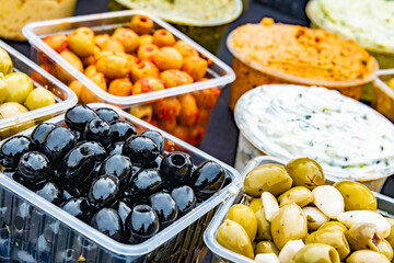 Olives in plastic boxes put up for sale in the store