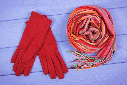 Woolen gloves and shawl for woman on boards, clothing for autumn or winter © ratmaner