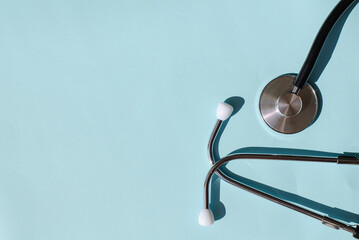 Stethoscope on a plain background. Phonendoscope. Medical device on the table. Patient diagnosis.
