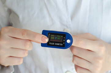 Pulse oximeter. Medical device on the finger. Patient diagnosis. Covid-19. Saturation measurement. Pulsometer. Glucometer. Blood sugar level. The level of oxygen in the blood. Tonometer.