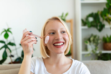 Woman doing self massage with rose quartz face roller