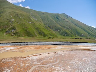 Natural mineral water spring in Truso valley, Kazbegi region, Caucasus mountains, Georgia.