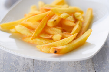 French fries or potato chips on white dish