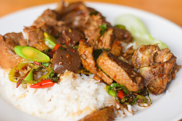 Rice topped with stir-fried duck and basil. Thailand food concept