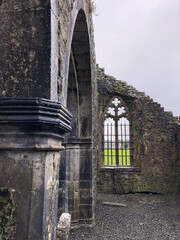 Naklejka premium Window from inside ruined medieval Franciscan Kilconnell Abbey in Galway county in Ireland