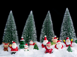 Santa Claus on White Snow with Blur Christmas Tree Background,Card or Poster for Merry Christmas and Happy New Year 2023 Concept,Free Space for Presentation,Celebration Xmas Decoration Festive Holiday