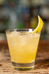 Penicillin cocktail on the bar. Blurred background.Summer refreshing drink, side view