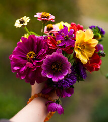 beautiful autumn bouquet in  female hand  on blurred background