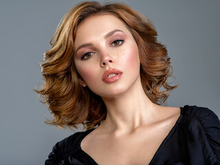 Beautiful brown haired with stylish short hairstyle. Woman with a  curly hair. Beautiful young...