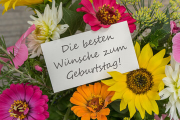german Birthday card with colorful summer flowers and the lettering: Best wishes for your birthday