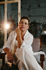 Portrait of a woman in a film studio with lighting equipment.