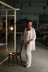 A mature woman poses in a film studio.