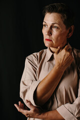 Dramatic portrait of a mature woman. Low key.