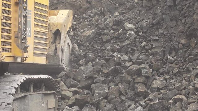 Slow motion loading of an excavator into mining truck 4K