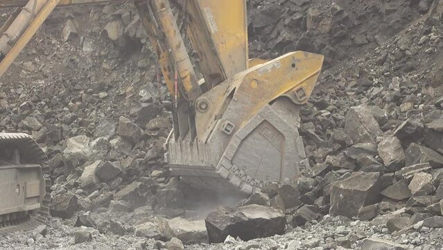 Slow motion loading of an excavator into mining truck 4K