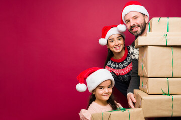Cheerful family receiving a lot of christmas presents during the holidays