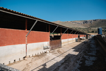 Concrete barn building near mountain