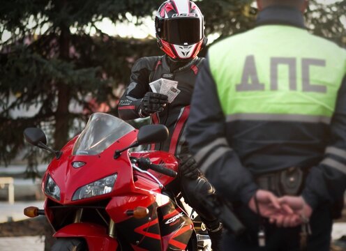 KRASNOYARSK, RUSSIA - April 5, 2020: Police officer stopped a motorcyclist on a red sportbike Honda CBR 600 RR