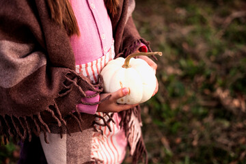 girl n linen wear holding a pumpkins.autumn background