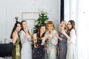 Happy party cracker with confetti and streamer of young women in celebrate New Year together at the...