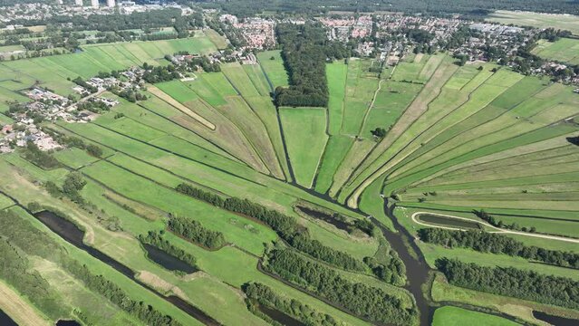 Loosdrecht recreational water river and meadow rural grass land green marsh in beautifull pattern small rivers and waters in nature. Dutch holland flat country side nature. Aerial drone.