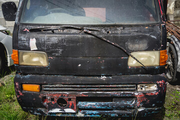 Front of an rusty car in garage