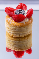 vol au vent with blueberry, puff pastry stuffed with berries on a mirror