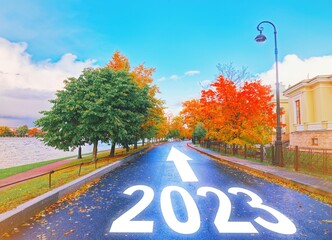 Empty car road drive, arrow sign path view. New year 2023 next goal. Trip way start, travel ahead...