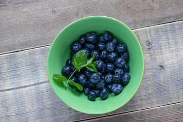 bowl of blueberries with mint leaves.