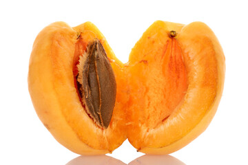 Two halves of pineapple apricot with a seed, macro, isolated on white.