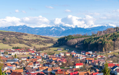 Fototapeta na wymiar Lucky village, Slovakia, Europe. Aerial view, Tatra mountains, cloudy sky and forest. Sunny spring day.