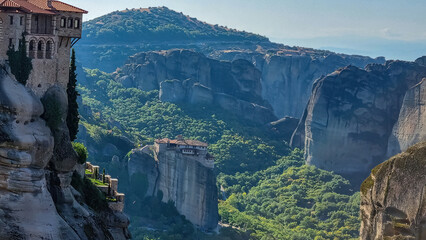 Scenic view of Holy Monastery of Rousanou seen from Monastery of Varlaam in Kalambaka, Meteora, Thessaly, Greece, Europe. Dramatic landscape. Dramatic orthodox landmark build on unique rock formations