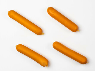 Smoked sausages on white background, top view.