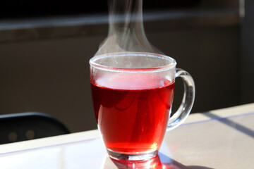 hot mate tea with steam in a transparent cup