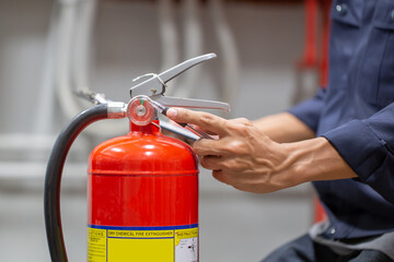 Engineer are checking and inspection a fire extinguishers tank in the fire control room for safety training and fire prevention.