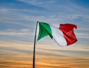 Italian flag waving on sunset sky