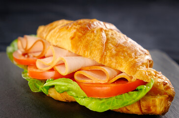 ham and cheese croissant on black slate board